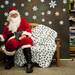 Santa sits in a chair waiting for the next dog to be photographed at Pet Supplies Plus on Saturday. All proceeds are donated to the Humane Society. Daniel Brenner I AnnArbor.com